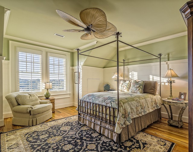 Picture of a bedroom with a tropical ceiling fan.